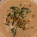 Blumenkohlcremesuppe im Teller mit gerösteten Blumenkohlstücken und Schnittlauch